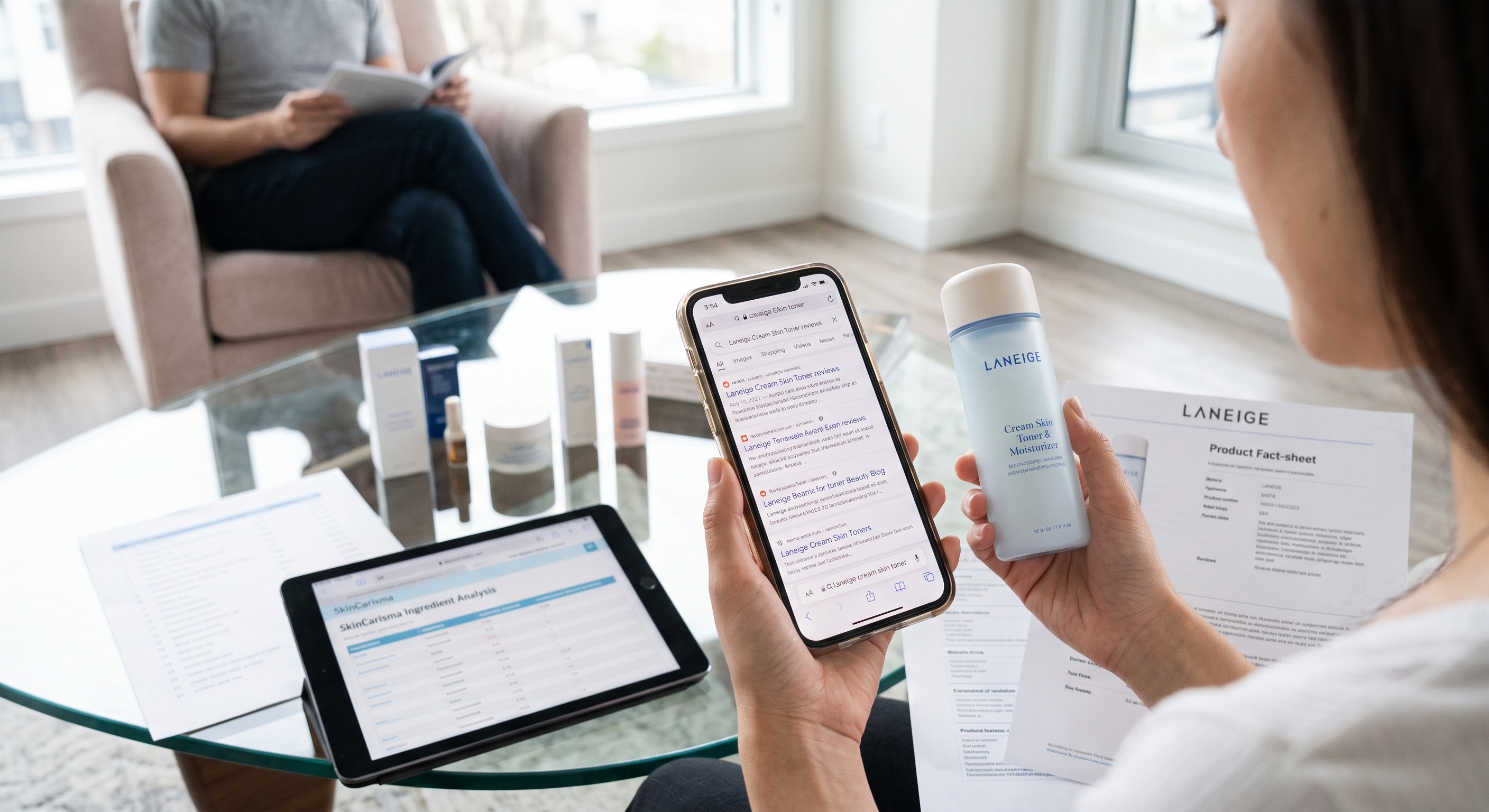 Person holding Laneige toner and smartphone displaying product reviews with ingredient analysis tablet on table.