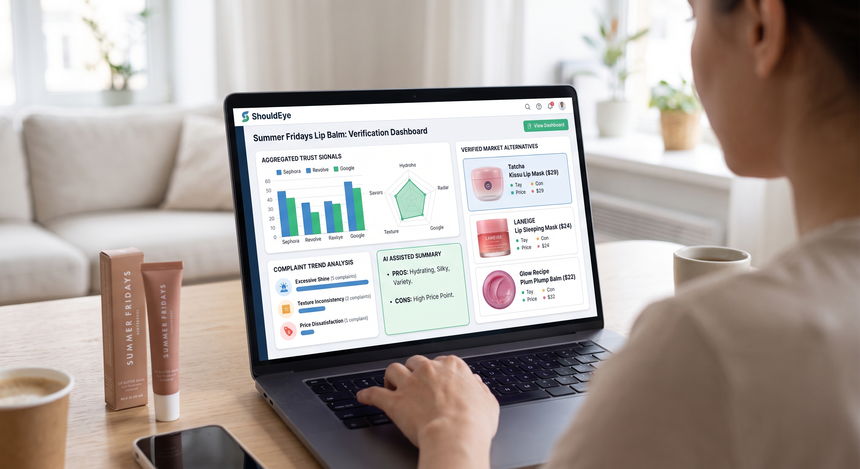 A person views the ShouldEye verification dashboard for Summer Fridays Lip Balm on a laptop next to lip balm tubes.