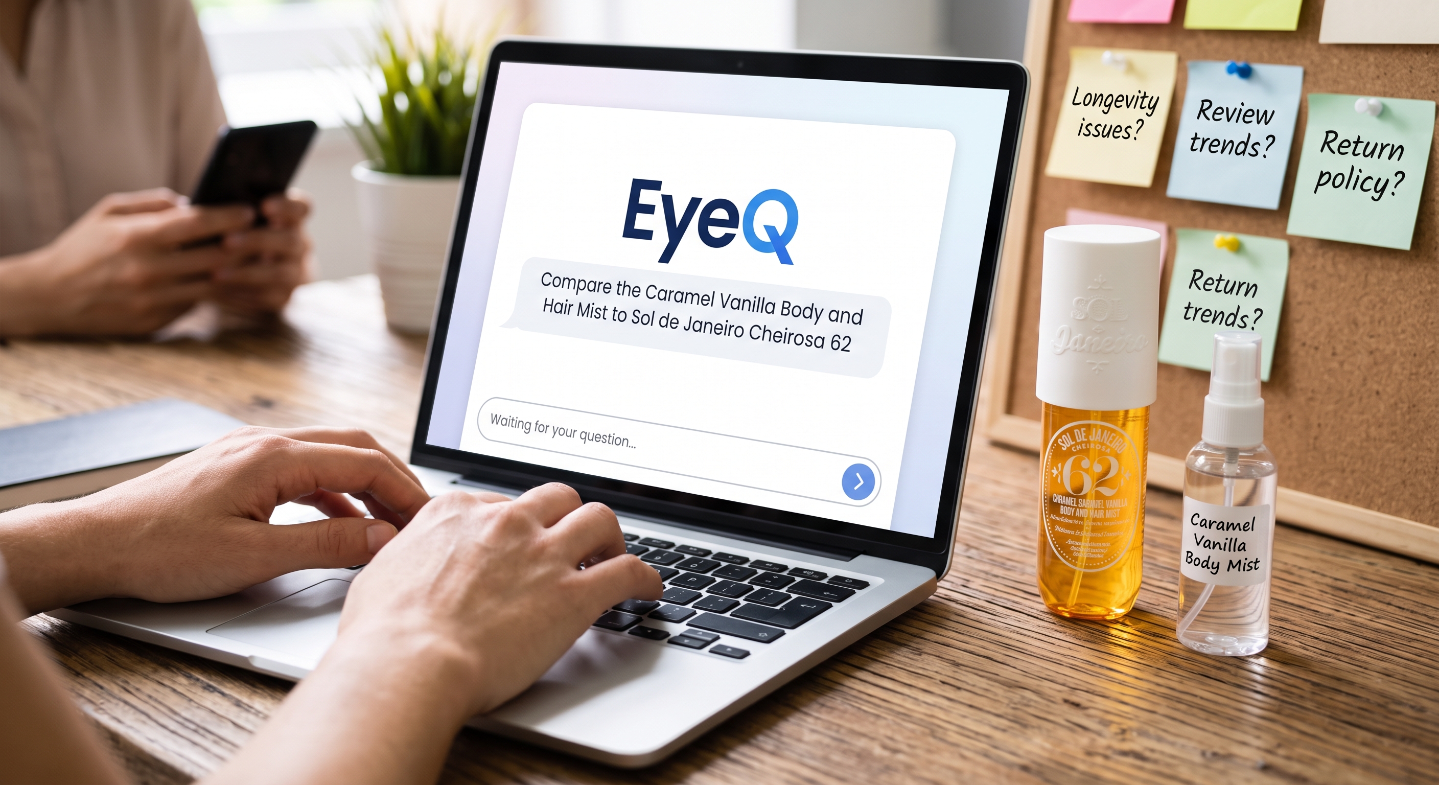 Hands typing on a laptop with the EyeQ interface comparing perfumes, next to a mood board and two fragrance bottles.