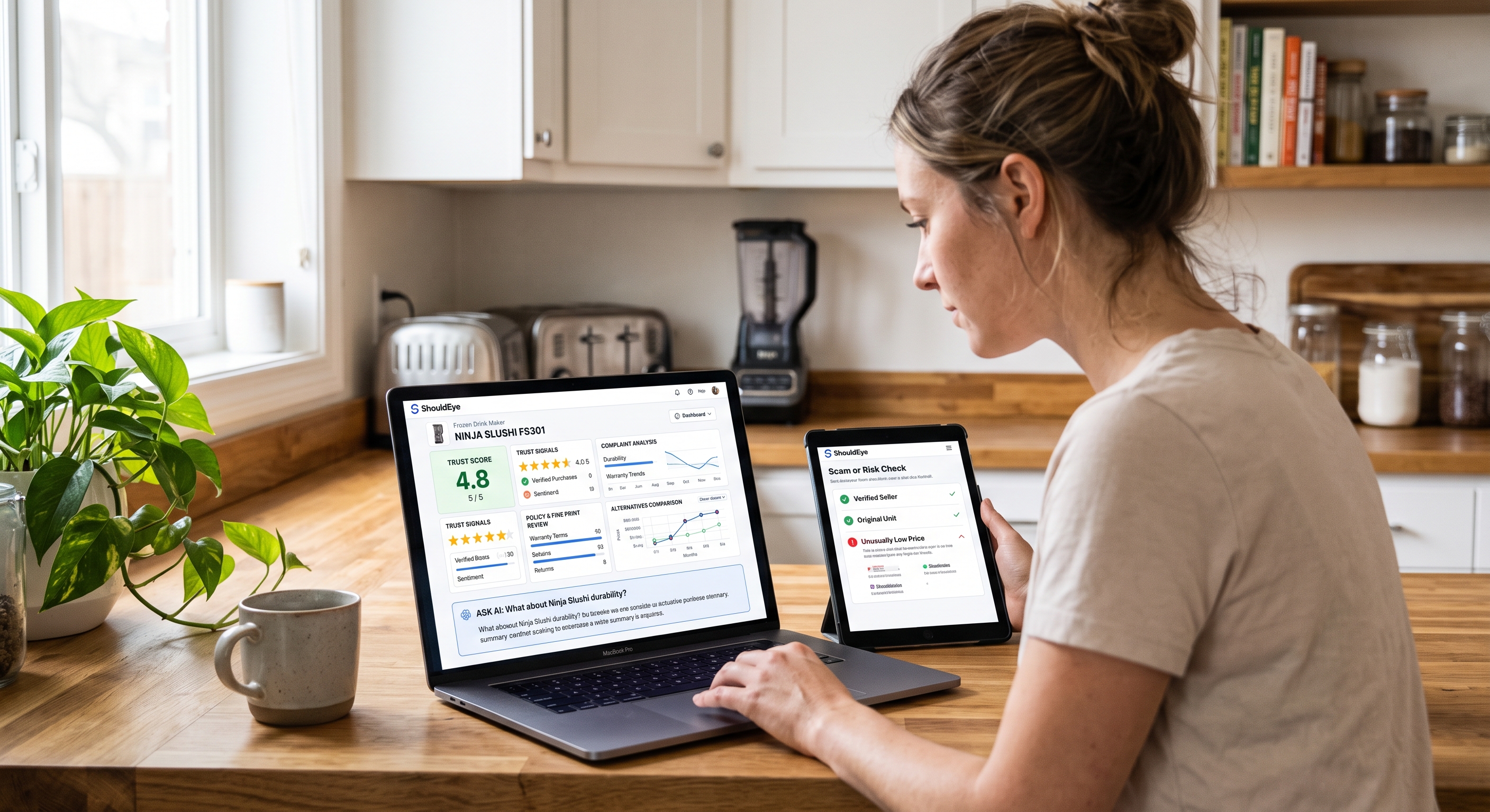 A woman in a kitchen uses a laptop showing a product trust dashboard and a tablet displaying a risk check.